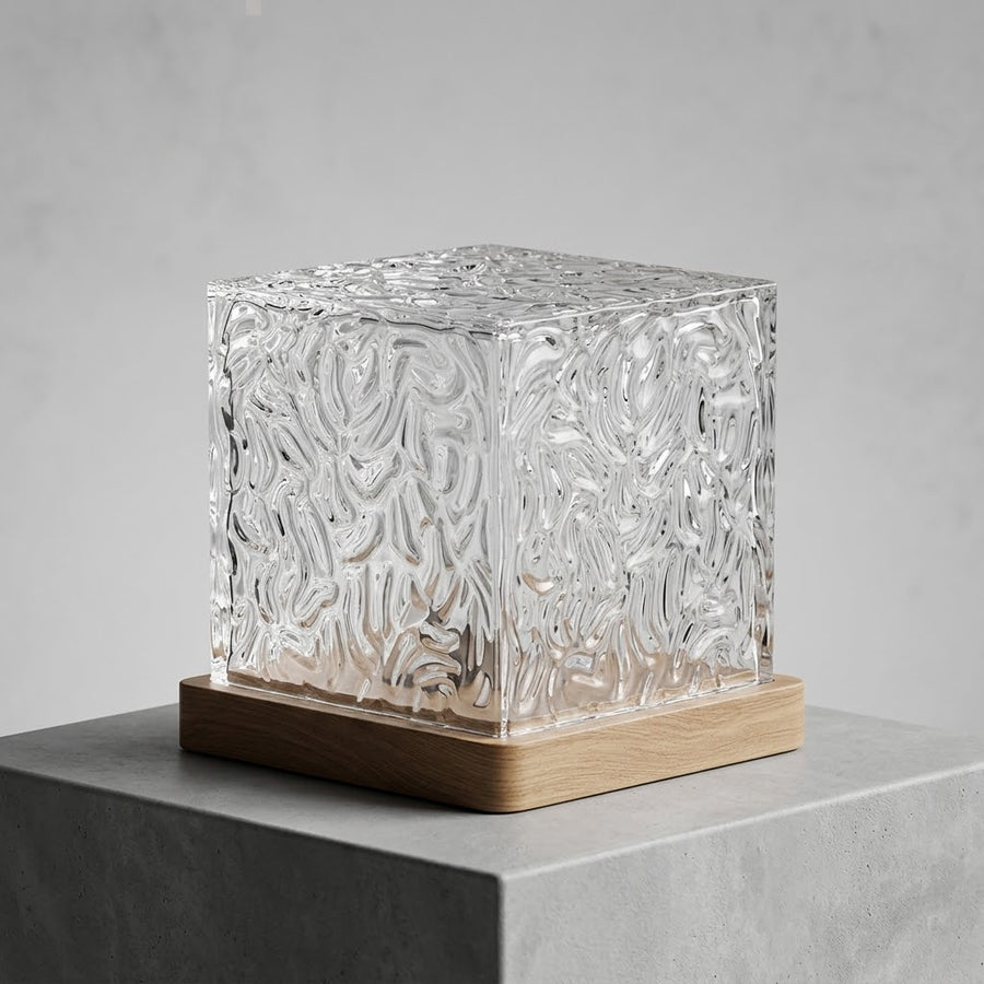 AURA Cube lamp glowing on a bedside table, water-ripple reflections across the wall